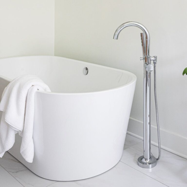 close up of soaking tub in this spa-like Atlanta bath renovation with a walk-in shower custom floating cabinets and custom storage tower