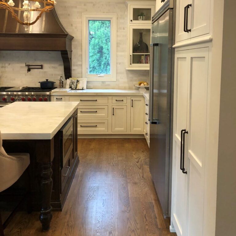 the kitchen remodel features custom cabinets luxury appliances and a microwave in the island