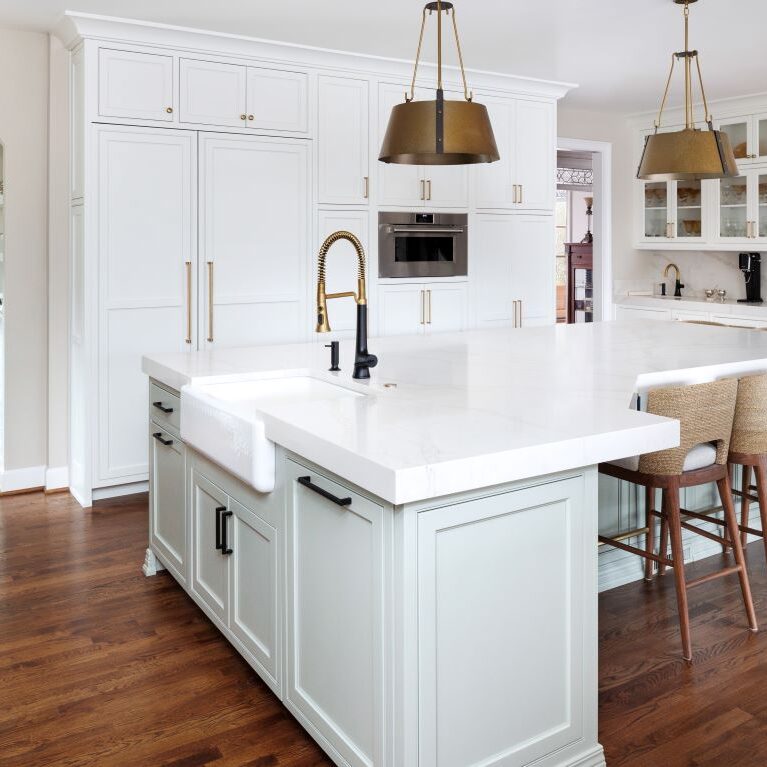view of large kitchen island in a renovated Marietta, GA home in Atlanta Country Club with white custom cabinets from Schuon Kitchens & Baths from Roswell GA