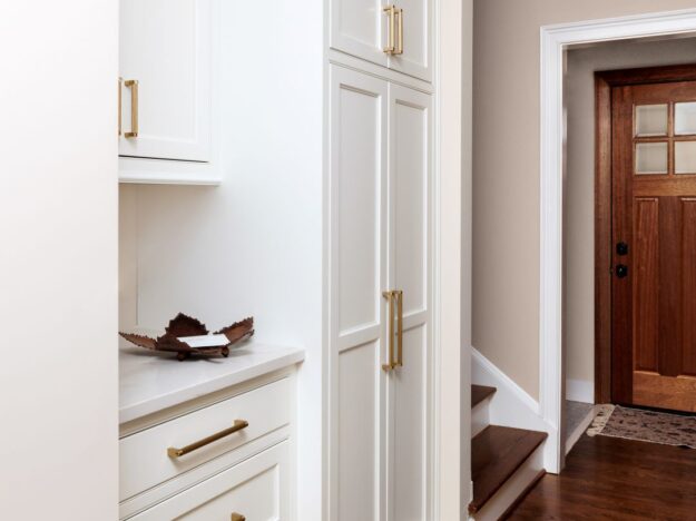 white custom cabinets in a hallway between a powder room and laundry area to provide extra storage in a beautiful home in Atlanta Country Club in Marietta Georgia