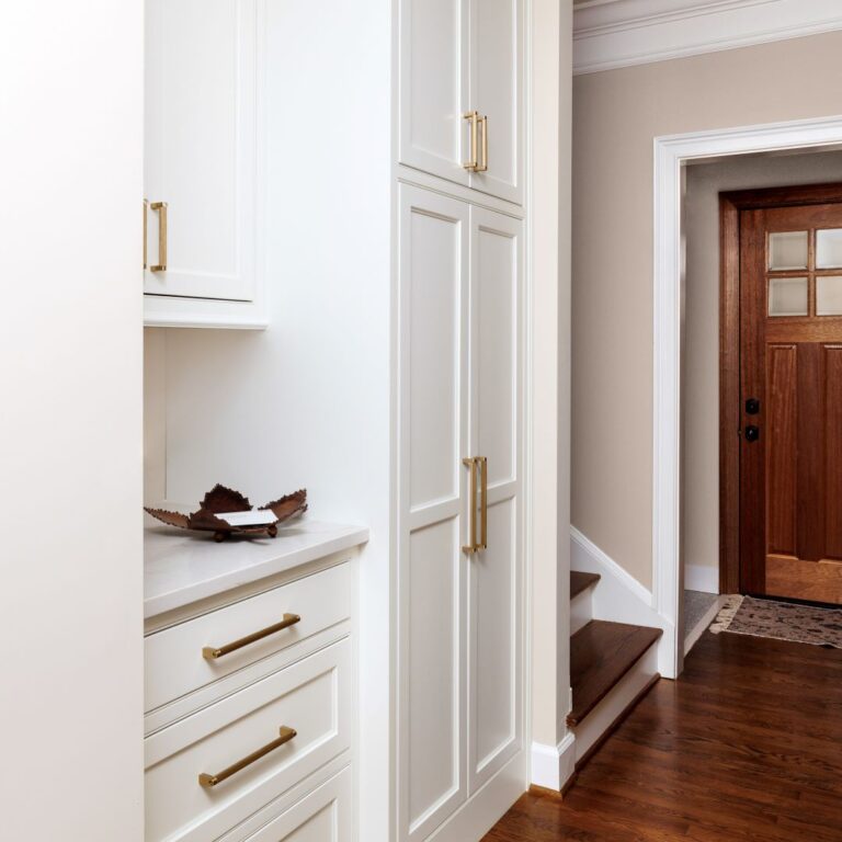 white custom cabinets in a hallway between a powder room and laundry area to provide extra storage in a beautiful home in Atlanta Country Club in Marietta Georgia