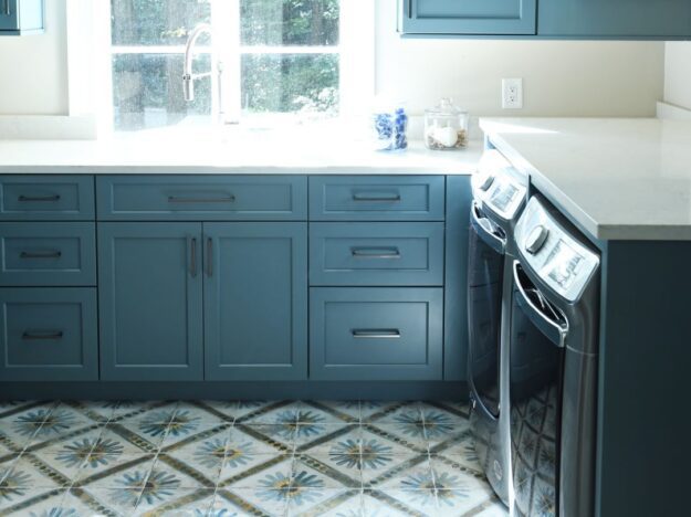 picture of a laundry room with blue cabinets and vibrant blue and brown floor tile in buckhead