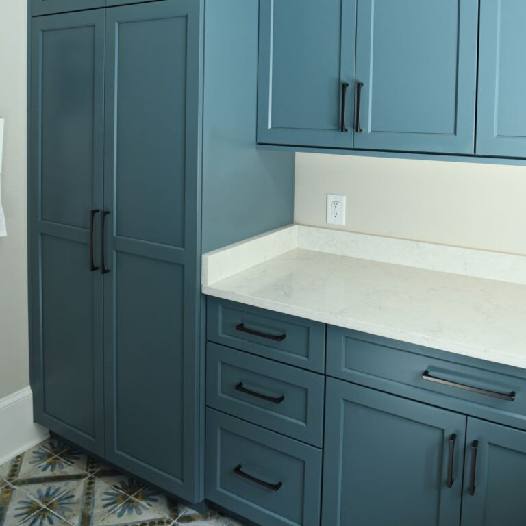 picture of blue laundry room cabinets and fun vibrant floor tile in an Atlanta renovation