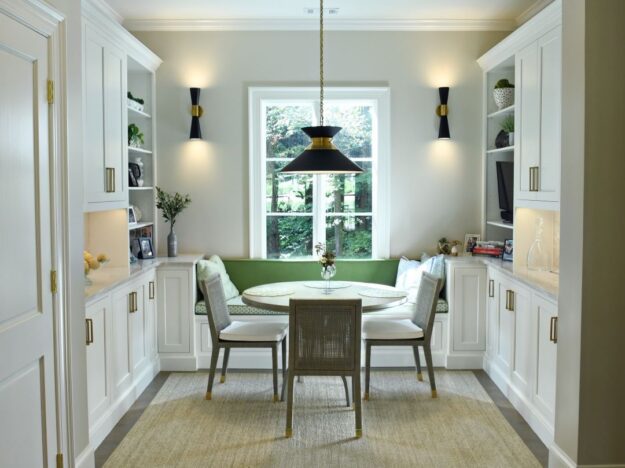 view of a cozy breakfast nook that was recently renovated in Atlanta with white cabinets and a window seat