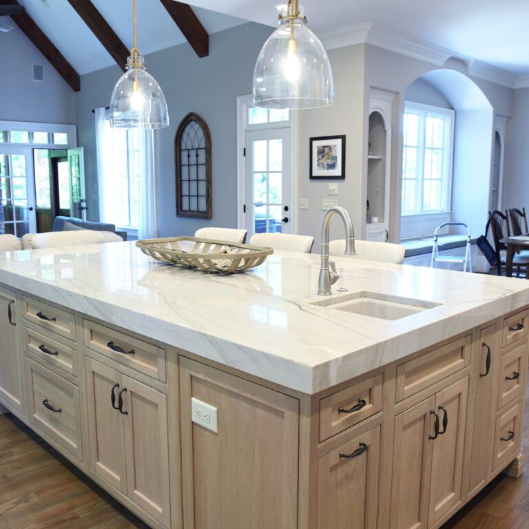a large island with lots of storage space is the center point of this beautiful kitchen renovation in marietta ga