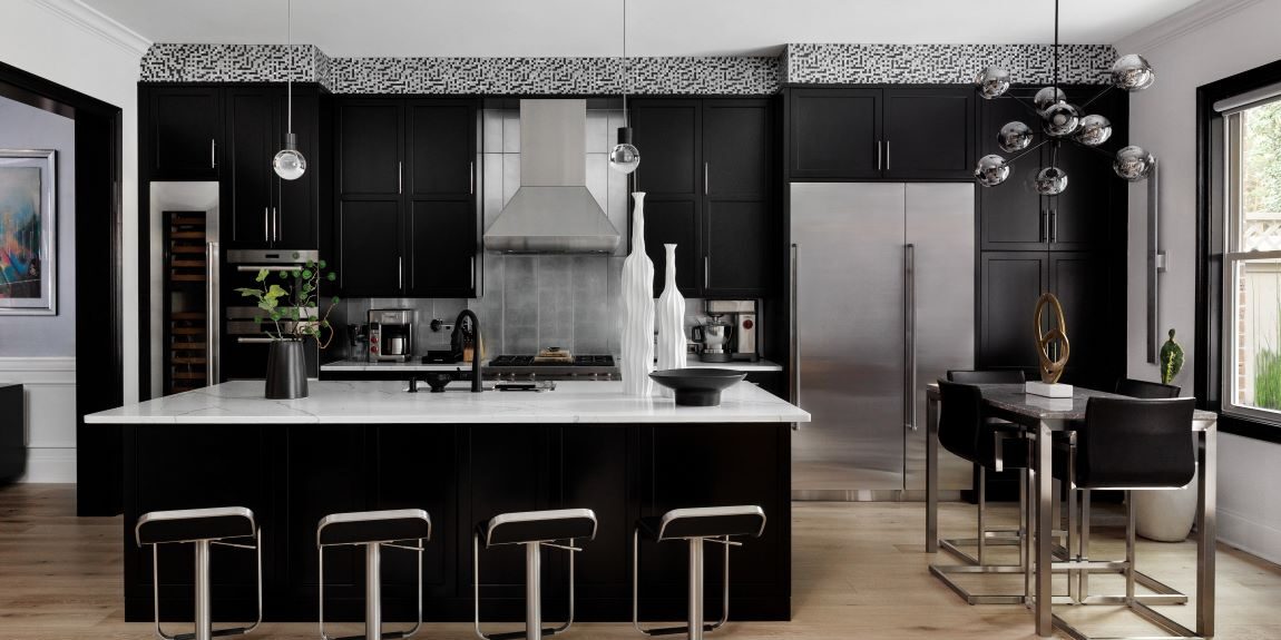 Alpharetta townhouse with modern black cabinets and silver accents with large island and seating for four