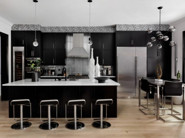 Alpharetta townhouse with modern black cabinets and silver accents with large island and seating for four