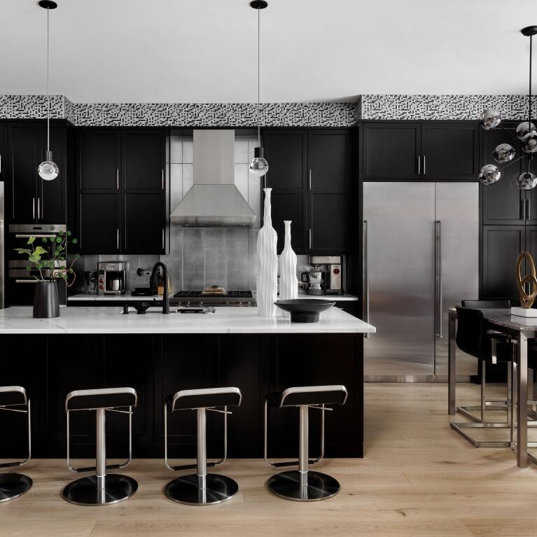 Alpharetta townhouse with modern black cabinets and silver accents with large island and seating for four