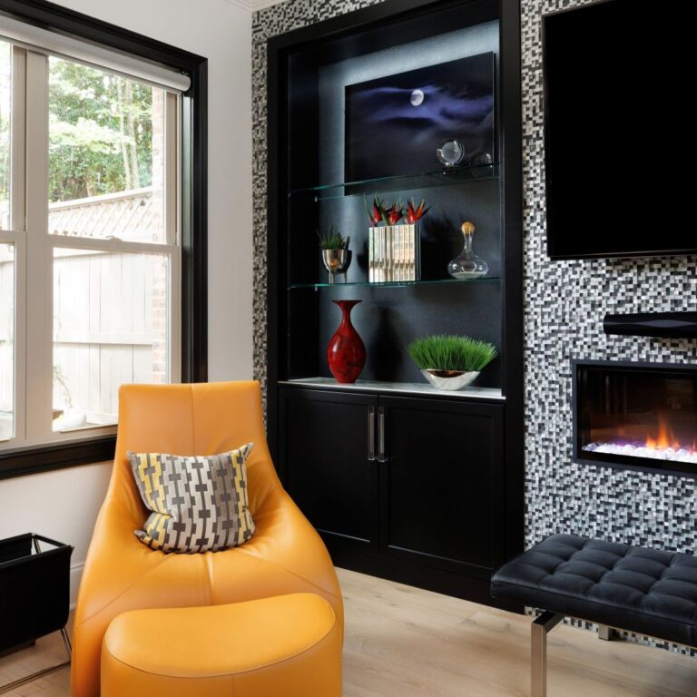 The black built in cabinets in the living room of this Alpharetta townhome offer beautiful and functional display and storage space.