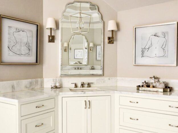 this elegant bathroom renovation in Brookhaven features two white vanities along with a steam shower, soaking tub, and linen tower