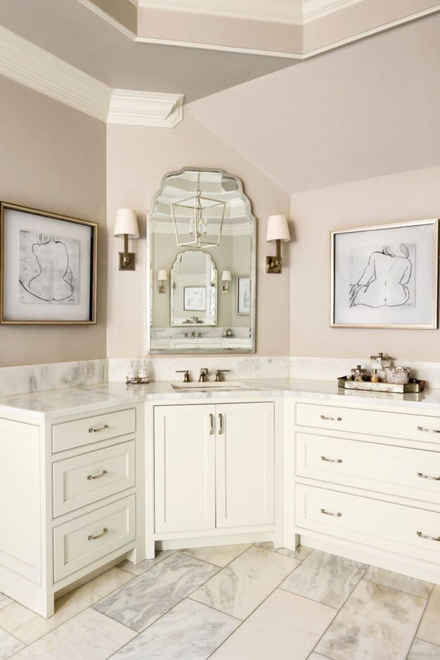 this elegant bathroom renovation in Brookhaven features two white vanities along with a steam shower, soaking tub, and linen tower