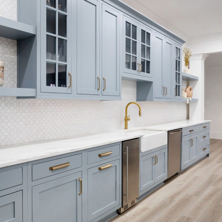 this basement kitchenette in buckhead atlanta, ga features light blue fitted cabinets, a mini fridge, and a dishwasher