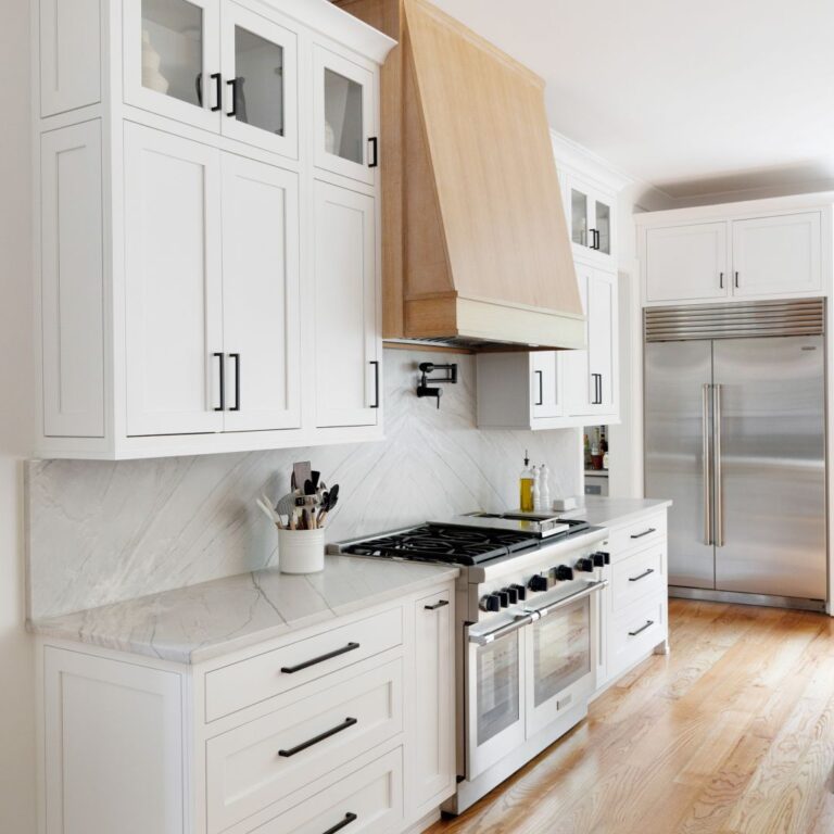a focal point of this kitchen renovation in buckhead atlanta is a natural wood colored vent hood that matches the island