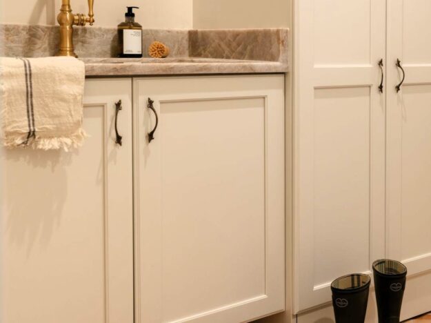 picture of mudroom cabinets in a Sandy Springs renovation with a lower vanity cabinet with a sink and a taller storage cabinet