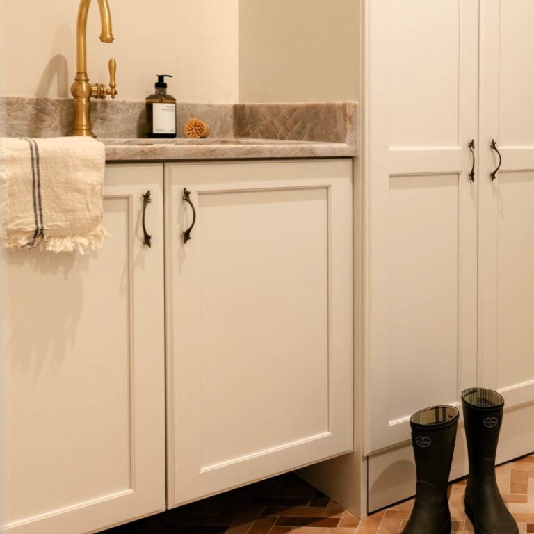 picture of mudroom cabinets in a Sandy Springs renovation with a lower vanity cabinet with a sink and a taller storage cabinet
