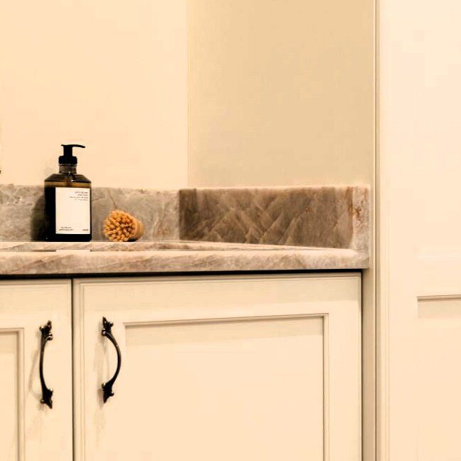 sophisticated mudroom in sandy springs home with custom Mouser cabinets and elegant quartzite