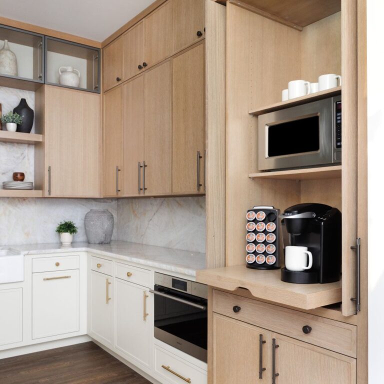 Convenience meets design with thoughtful details like a hidden Keurig coffee station in this high-end kitchen display in Roswell.