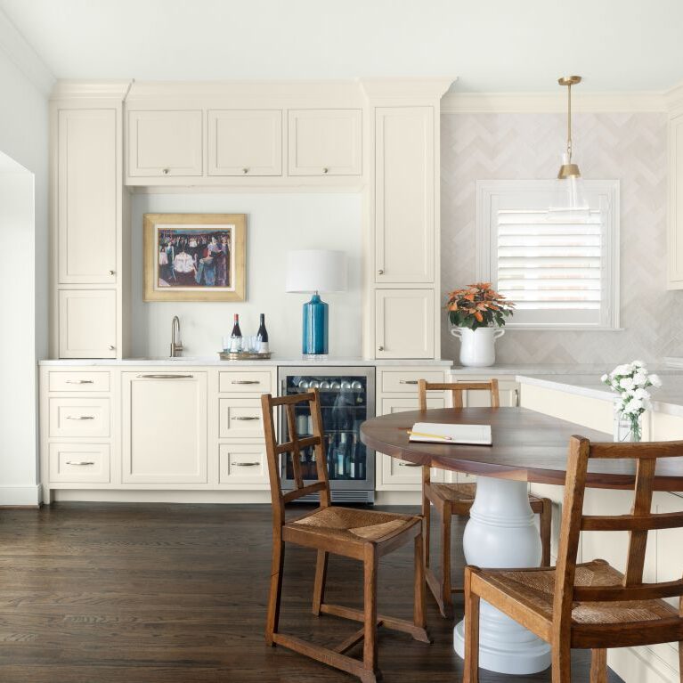 view from half table integrated into island and looking toward beverage station in this vibrant vinings kitchen transformation