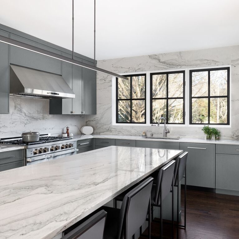 modern buckhead kitchen renovation with grey cabinets white quartz with grey veining and large island seating four