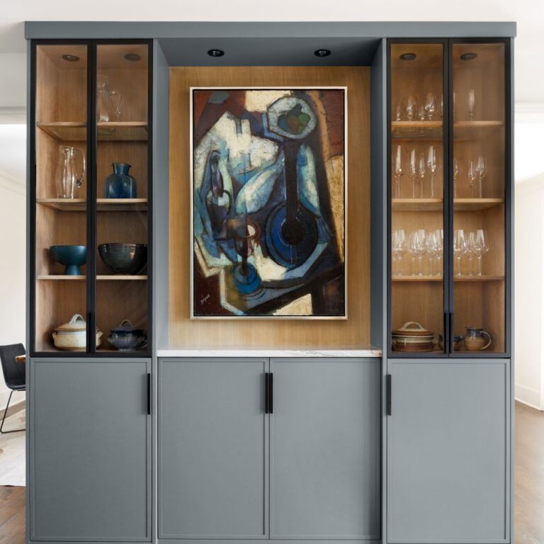 built-in china cabinet in a contemporary buckhead kitchen renovation featuring grey lower cabinets and contrasted with light wood upper cabinets with glass doors and dramatic black frames