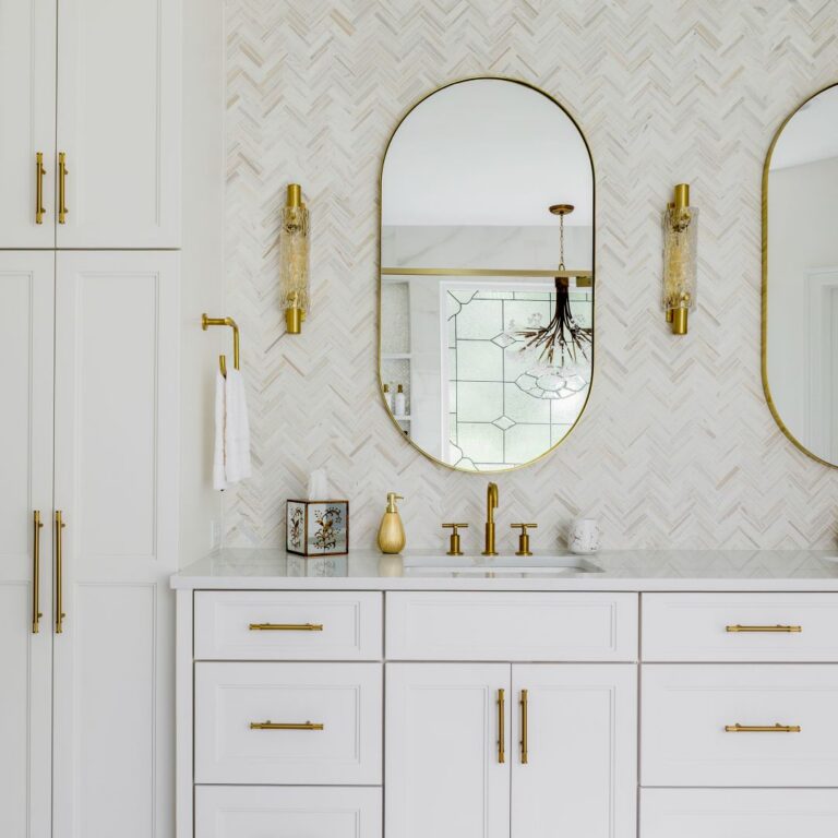 Custom white linen tower and vanity with quartz countertop and brushed-gold hardware